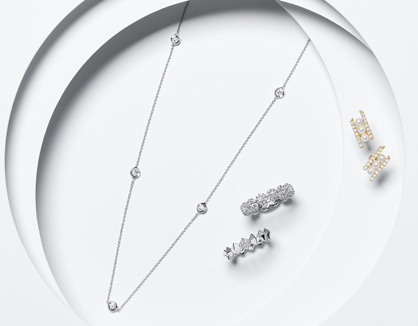 yellow gold earrings, white gold rings and a pearl necklace